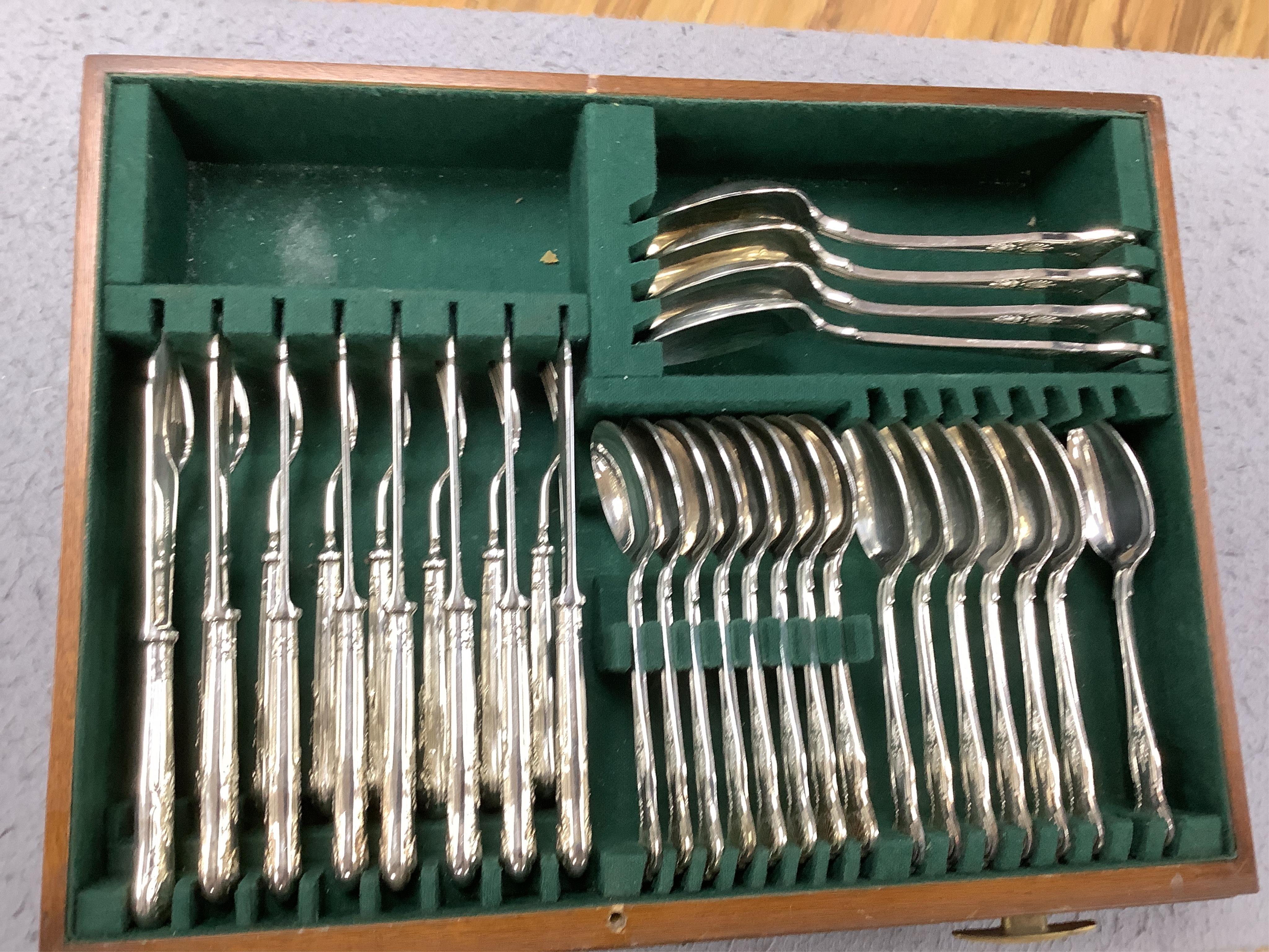 A walnut cased canteen of cutlery with drawer, retailed by Harrods. Condition - one dessert spoon missing